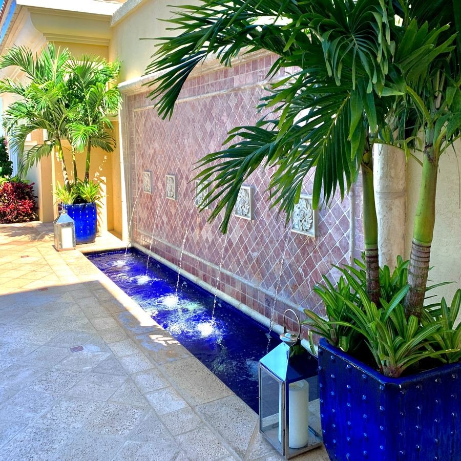 Interior water feature framed by tropical palms