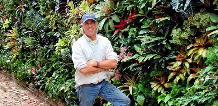 Biophilic designer Jeffrey Allis beside a lush living green wall